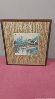 Full front view of framed watercolor painting with textured mat and wooden frame