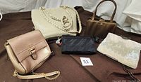 Group photo showing all five evening handbags including iridescent beaded clutch, gold mini crossbody bag, cream shoulder bag, bronze handbag, and black clutch