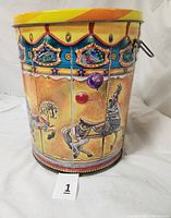 Side view of carousel tin can showing detailed carousel horses and vibrant carnival art style decorations with one attached handle