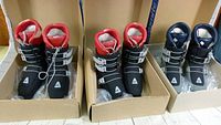 Three pairs of vintage Dolomite alpine ski inner boots in original boxes, two pairs with red interior padding, one with blue.