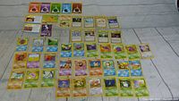 46 assorted Pokémon trading cards displayed in rows showing various characters and card types.