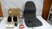 Full view of all items together showing the foot massager, chest expander, and Conair seat massager with controllers and power adapters.