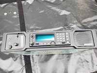 Front top view showing the display screen, keypad, speaker, and control knobs of the Harris desktop station.