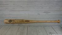 Full length view of the signed 2000 New York Mets collectible bat showing engraved signatures and markings