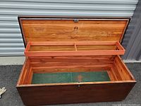 Open view of interior showing cedar lining and divider tray inside the blanket chest