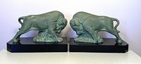 Front view of both bison bookends placed side by side on black marble bases showing detailed fur texture and stance.