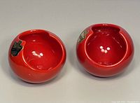 Two red vintage Belfor Pottery Italy ashtrays side by side, showing front and top view with original labels visible.