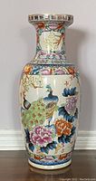 Front view of tall vintage Chinese porcelain floor planter vase showing peacock and floral design details
