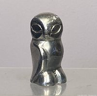 Front view of silver-toned owl figurine showing worn areas on the surface.