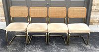Front view of four chairs in a row against garage door