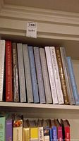 Shelf of hardcover decorating books spanning various titles
