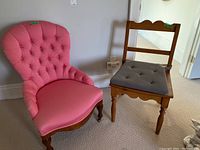 Two chairs positioned side by side: to the left a pink fabric high back tufted armchair, to the right a wooden chair with cushion.