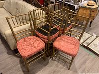 Six chairs grouped in a circle showing frames and upholstery