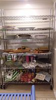 Full view of chrome wire shelving unit loaded with dishes and accessories