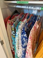 Closet rack with eight assorted over-nightshirts on hangers