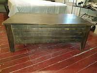 Front view showing slatted drawer front and tapered legs