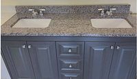 Front view of granite countertop with two undermount sinks and faucets installed