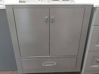 Front view of grey vanity cabinet showing two doors and bottom drawer with chrome handles