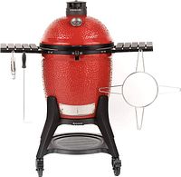 Front view of assembled red ceramic grill on cart with side shelves and hanging tools