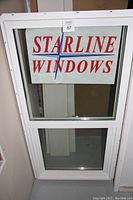 Full view of the 2' x 4' white vinyl window showing both upper and lower glass panels with Starline Windows signage.