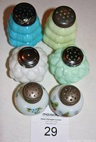 Top-down view of all six shakers showing variety of colors and metal tops