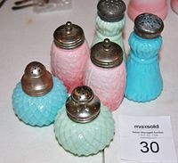 Overall view of 6 glass shakers showing the three pairs with different colors and designs.
