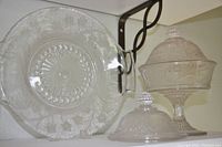 Photo showing the full 11-inch server plate laid flat with the high compote with lid and extra lid beside it on a white surface.