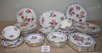 Full assortment of plates, cups and platter arranged on table
