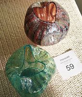 Two Dugan art glass 3-pinch Mica Rose bowls, one green and one amethyst, showing iridescence and textured surface