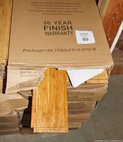 Top view of stacked Haosen flooring boxes with one plank sample exposed
