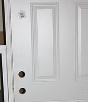 Close-up of front panels showing raised six-panel design and two pre-drilled bore holes.