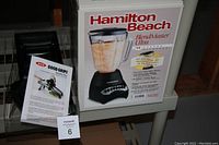 Photo showing boxed Hamilton Beach BlendMaster Ultra blender alongside Good Grips Mandolin slicer and instruction leaflet.