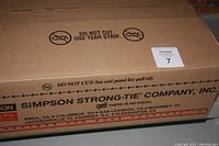 Box with Simpson Strong Tie branding and handling instructions indicating a sealed metal hardware kit.