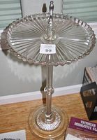 Full view of glass tray top with scalloped edges and chrome finial center