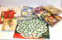 Photo showing all the decorative napkins and doilies arranged together on a white surface, displaying variety of holiday-themed designs.