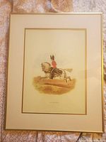Framed print of Royal Dragoon Guards soldier on white horse, showing full frame and matting.