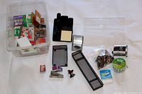 Overview of various home office supplies including organizers, stapler, staples, folders, and printer paper arranged on a white cloth.