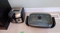 Photo of a Hamilton Beach electric pan with glass lid and deep fryer placed on floor