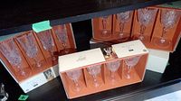 Original boxed sets of Cristal D'Arques Masquerade champagne flutes in orange and white box packaging.
