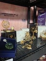 Shelf display of multiple Swarovski crystal and Crystal Temptations figurines and light catchers in their boxes.