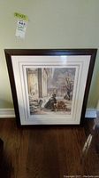 Full view of framed print leaning against wall