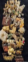 Overview of assorted large animal figural costume jewelry brooches on dark cloth