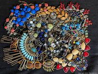 Top-down photo of assorted rhinestone costume necklaces in multiple colors and styles.