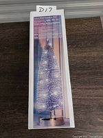 Box showing 14 inch silver glitter Christmas tree decoration with LED lights, battery powered