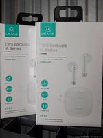 Front view of two boxed USAMS TWS Earbuds IA Series units, highlighting model number, Bluetooth 5.0 feature, and product images on packaging.