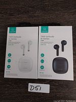 Front view of two USAMS TWS IA Series earbuds retail boxes, one white and one black, both sealed.