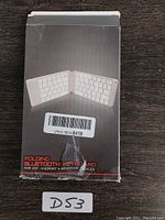 Front of retail packaging showing image of folded keyboard and text indicating compatibility with iOS, Android, and Windows devices.