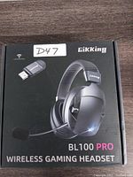 Front of the package showing Gikking BL100 Pro Wireless Gaming Headset with a USB adapter and microphone, model name and branding.