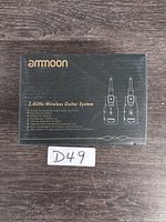 Front view of the Ammoon 2.4 GHz Wireless Guitar System box showing product name, features, and illustration of transmitter and receiver.