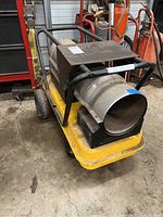 Full view of heater on yellow wheeled base with handle